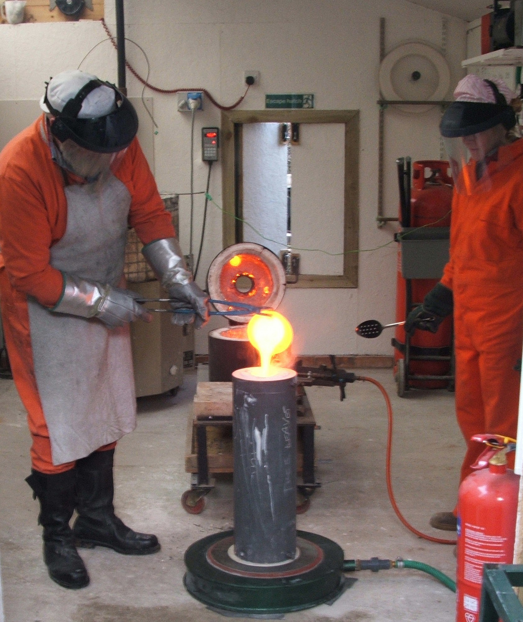 Pete and Sioban casting Bronze Pete pouring molten bronze