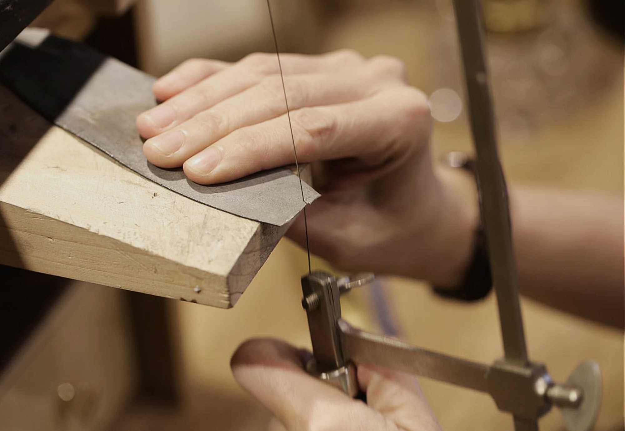 Cutting silver with a piercing saw hands cutting silver with a piercing saw